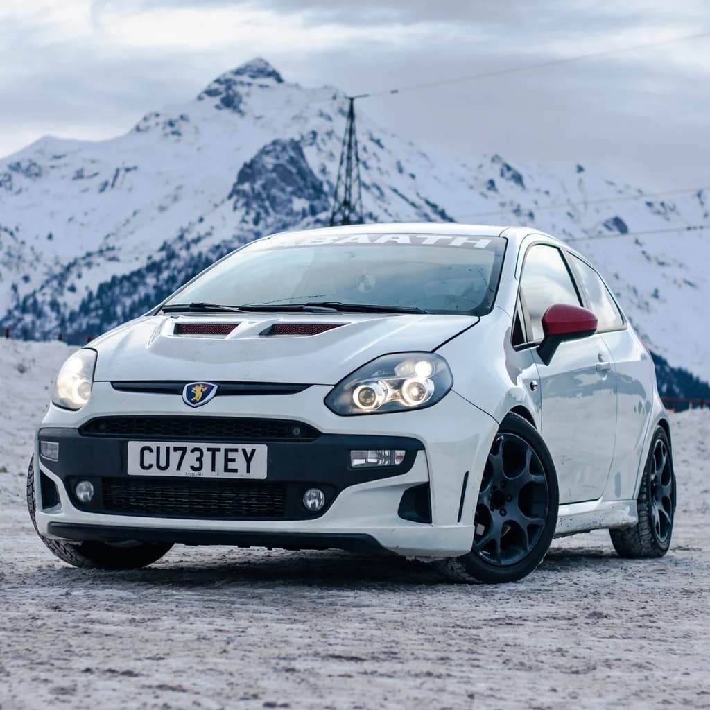 Photo of a white Fiat 500 Abarth showing the private number plate CU73 TEY, which reads as Cutey and is currently available for sale for £7,250.