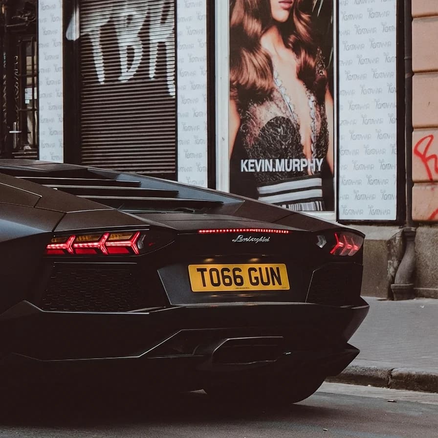 Photo of a matte black wrapped Lamborghini Aventador showing the private number plate TO66 GUN, which reads as Top Gun and is currently available for sale for £12,250.